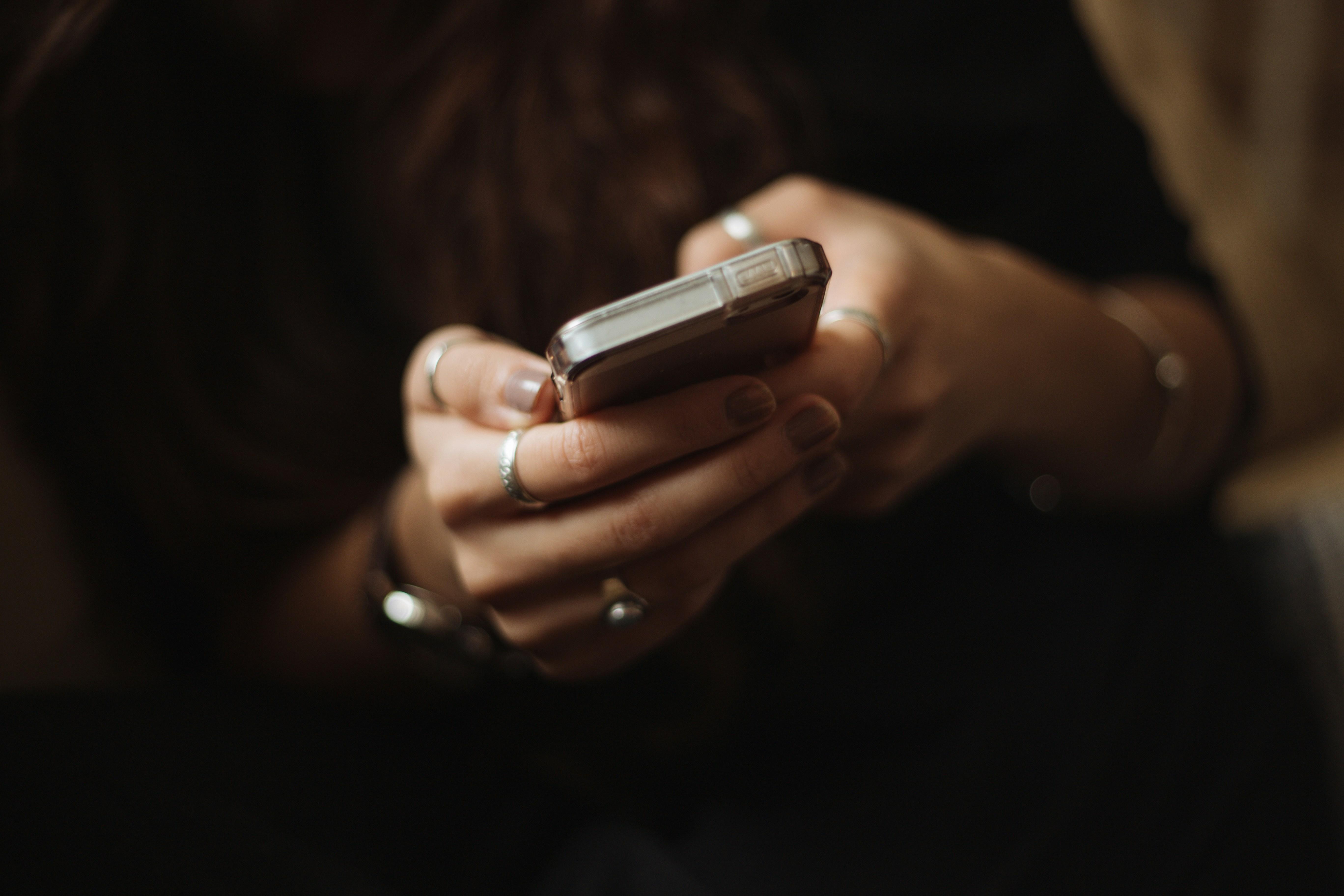 student texting on cell phone