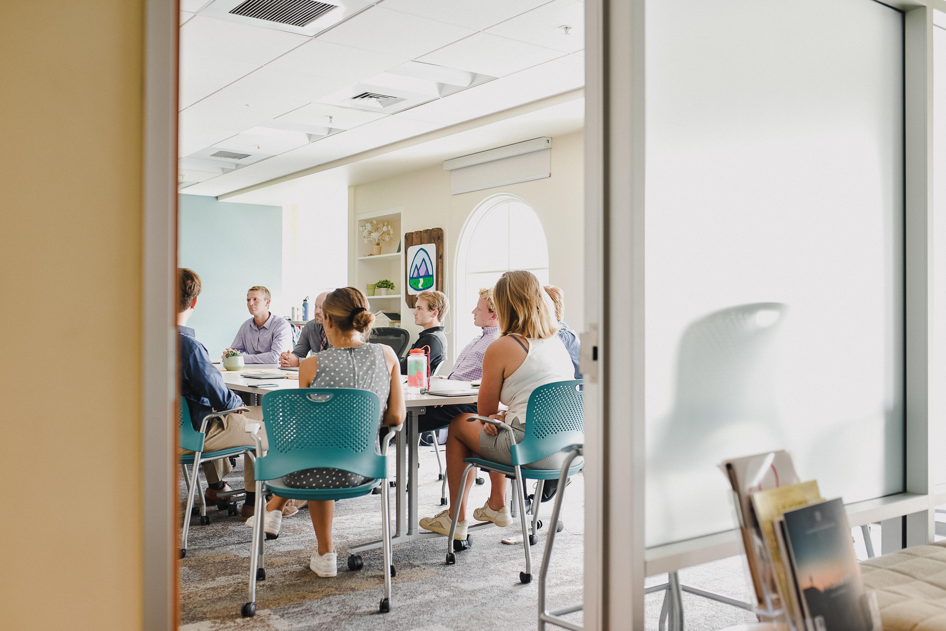 Group of students in discussion in classroom.